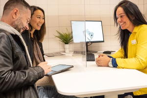 a-man-and-a-woman-smiling-while-planning-a-kitchen-with-an-i-342e3a7f182ab13c7e8c60fc9be74142